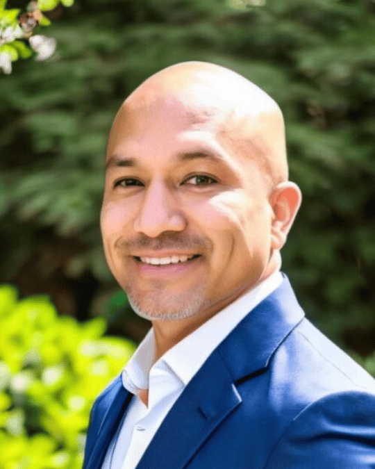 Dr. Issac E. Azevedo PMP, Smiling in professional portrait, Jonah Vale Founding Steward