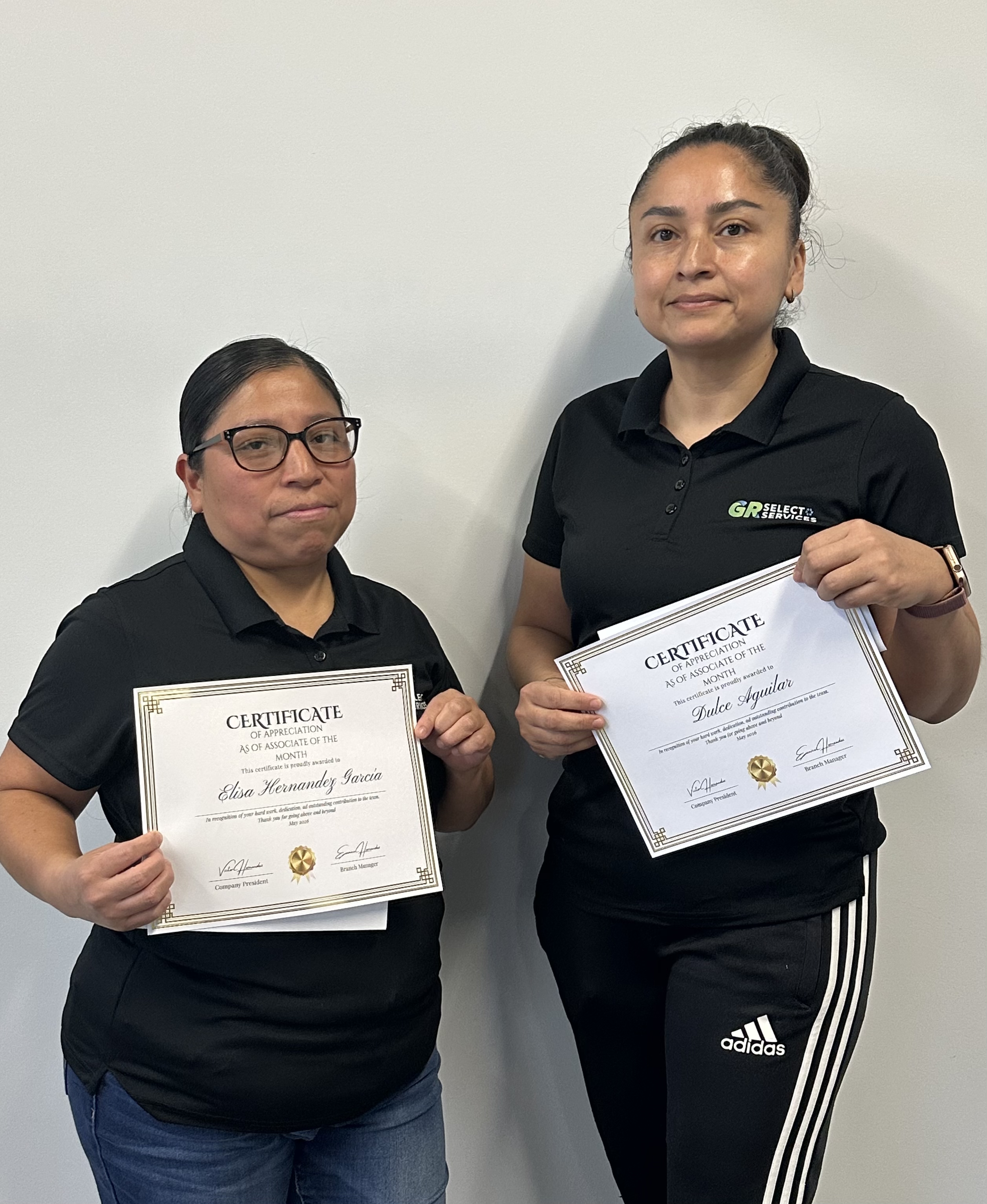Young woman with glasses holding a certificate of appreciation for Associate of the Month awarded to Thania Luna Porcayo.