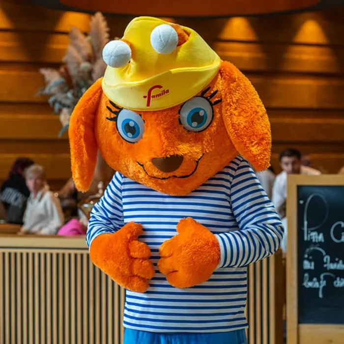 Maskottchen Luna mit gelber Mütze im Einkaufsland Wechloy zwischen Besuchern