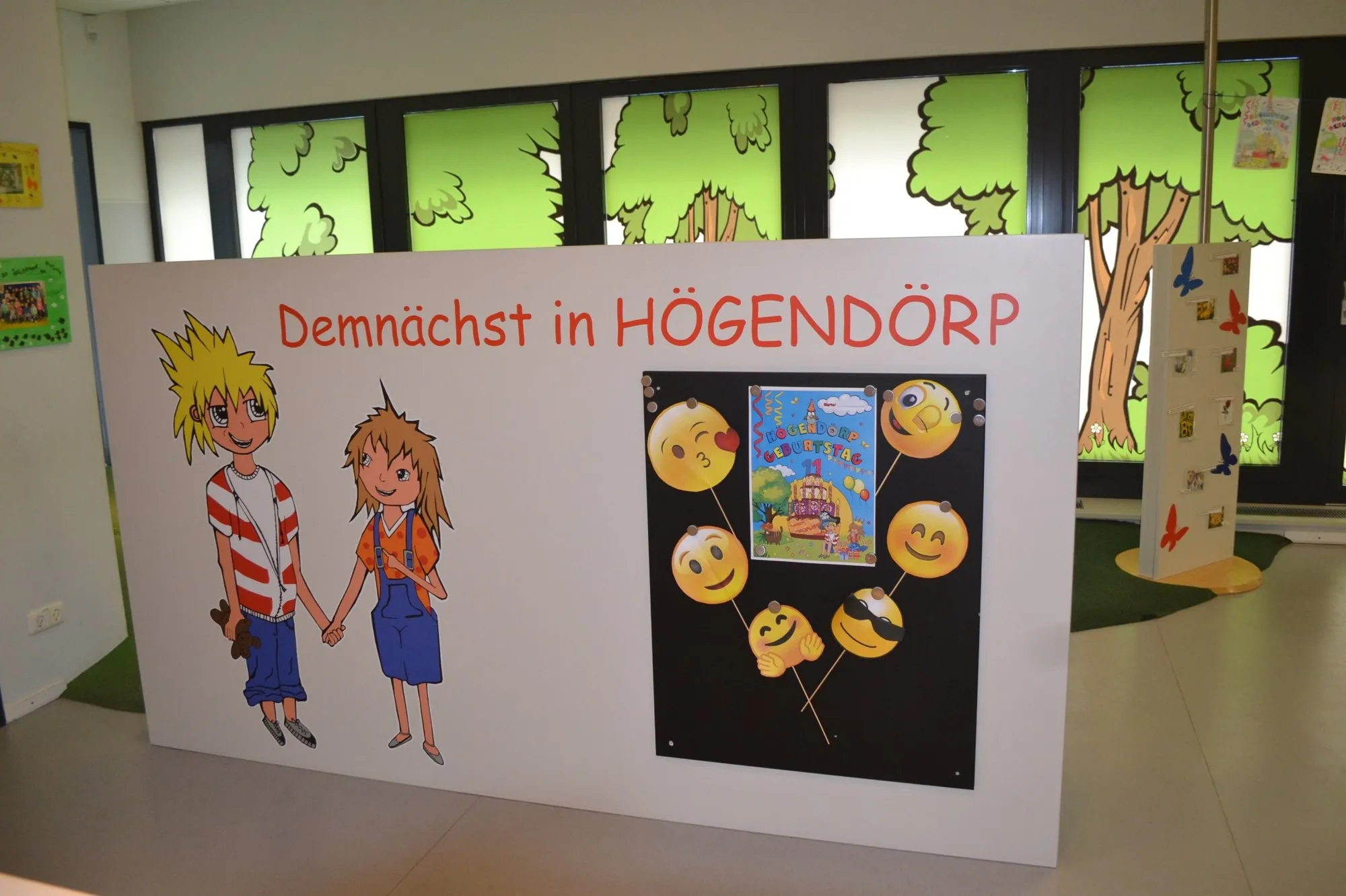 Hinweistafel mit Comic-Figuren und Event-Ankündigung im HÖGENDÖRP Kinderbereich