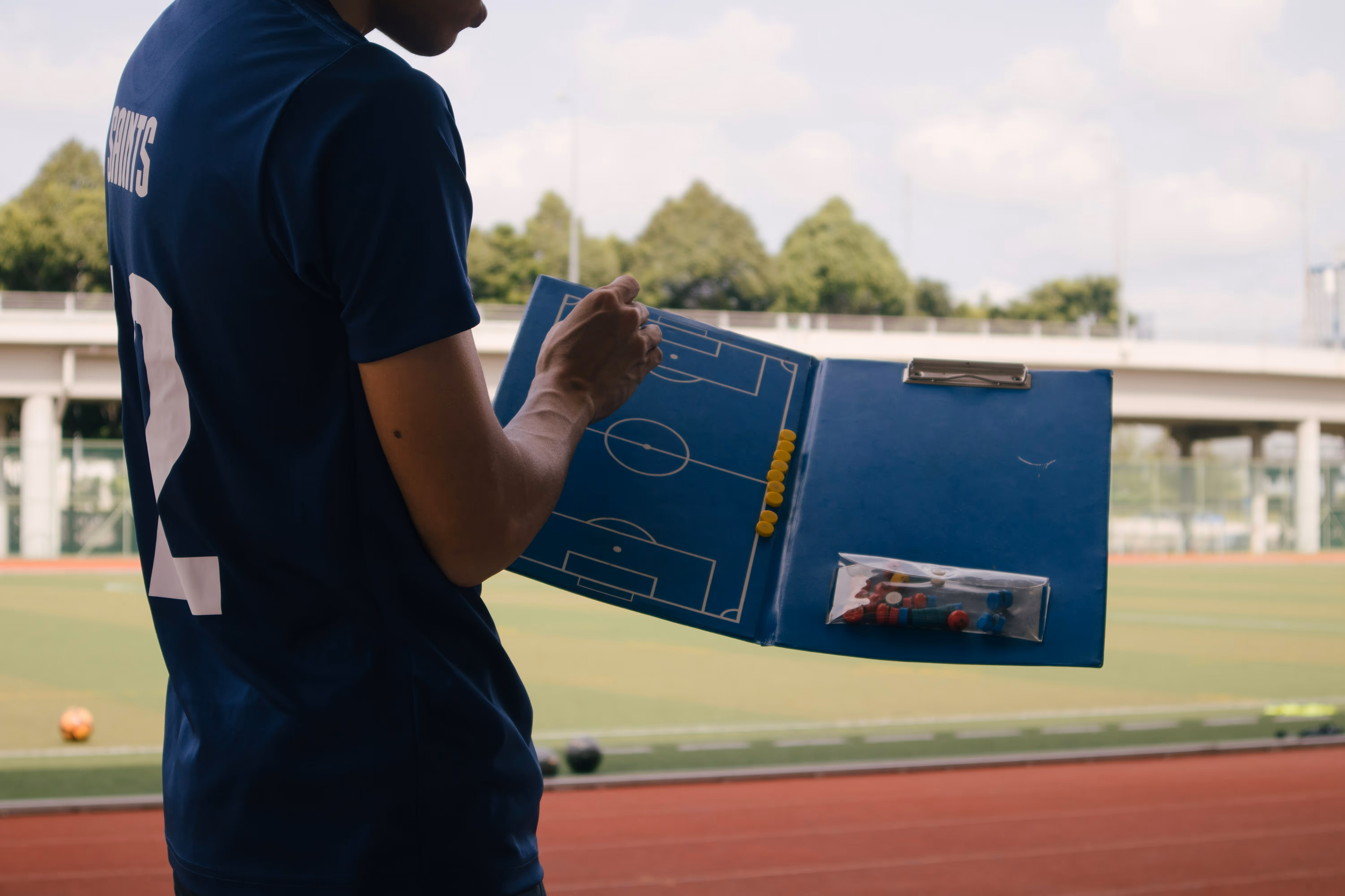 A trainer with a plan of the soccer field