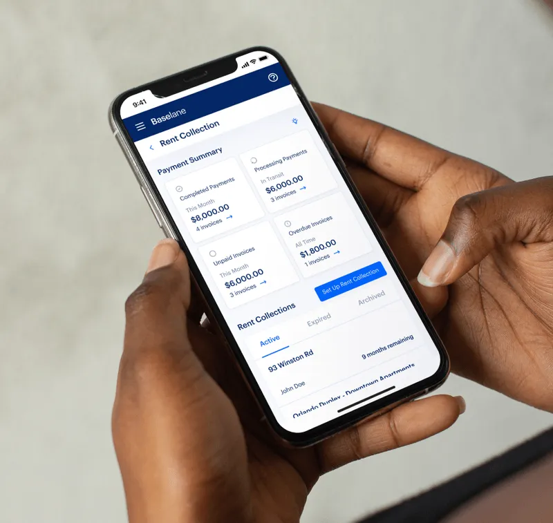A user holding smartphone that shows Baselane screenshot