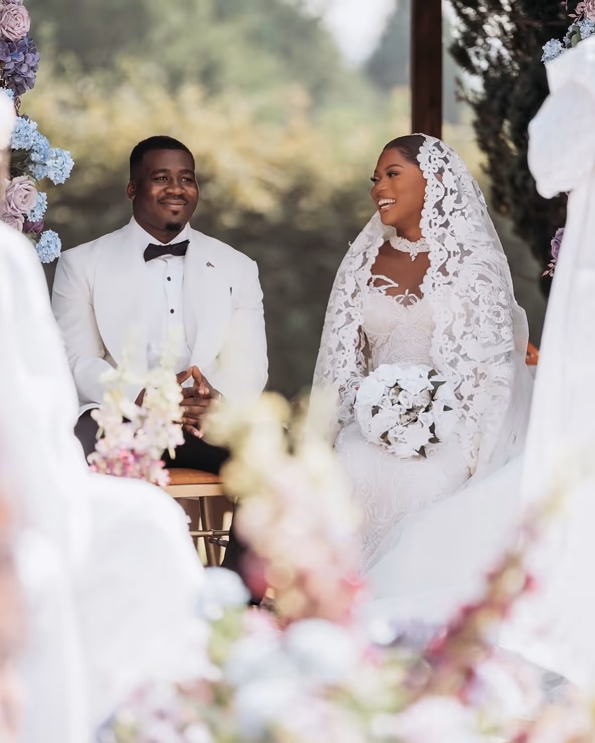 Bride and groom reciting vows at outdoor wedding.