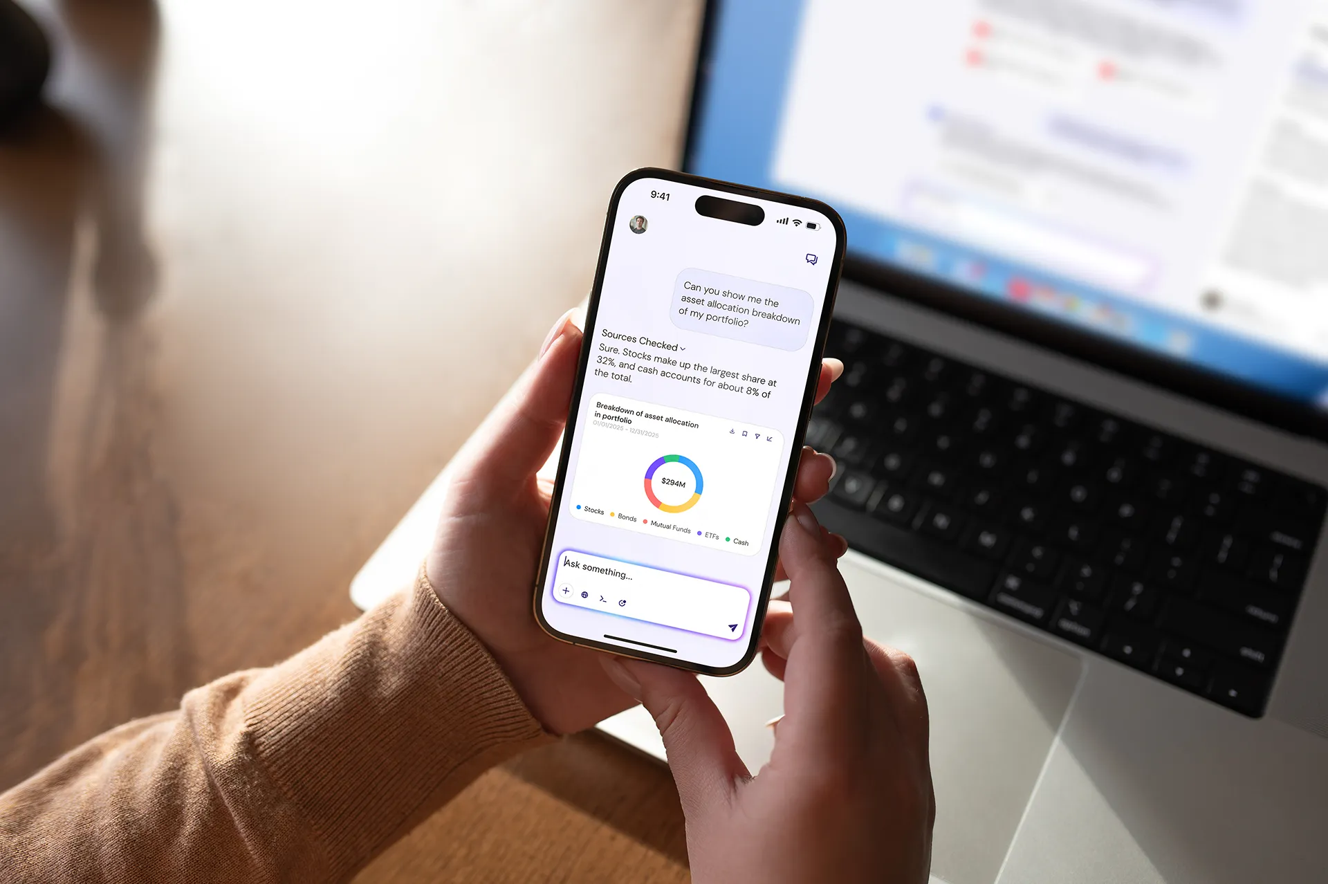 A hand holding a phone that is showing a graph.