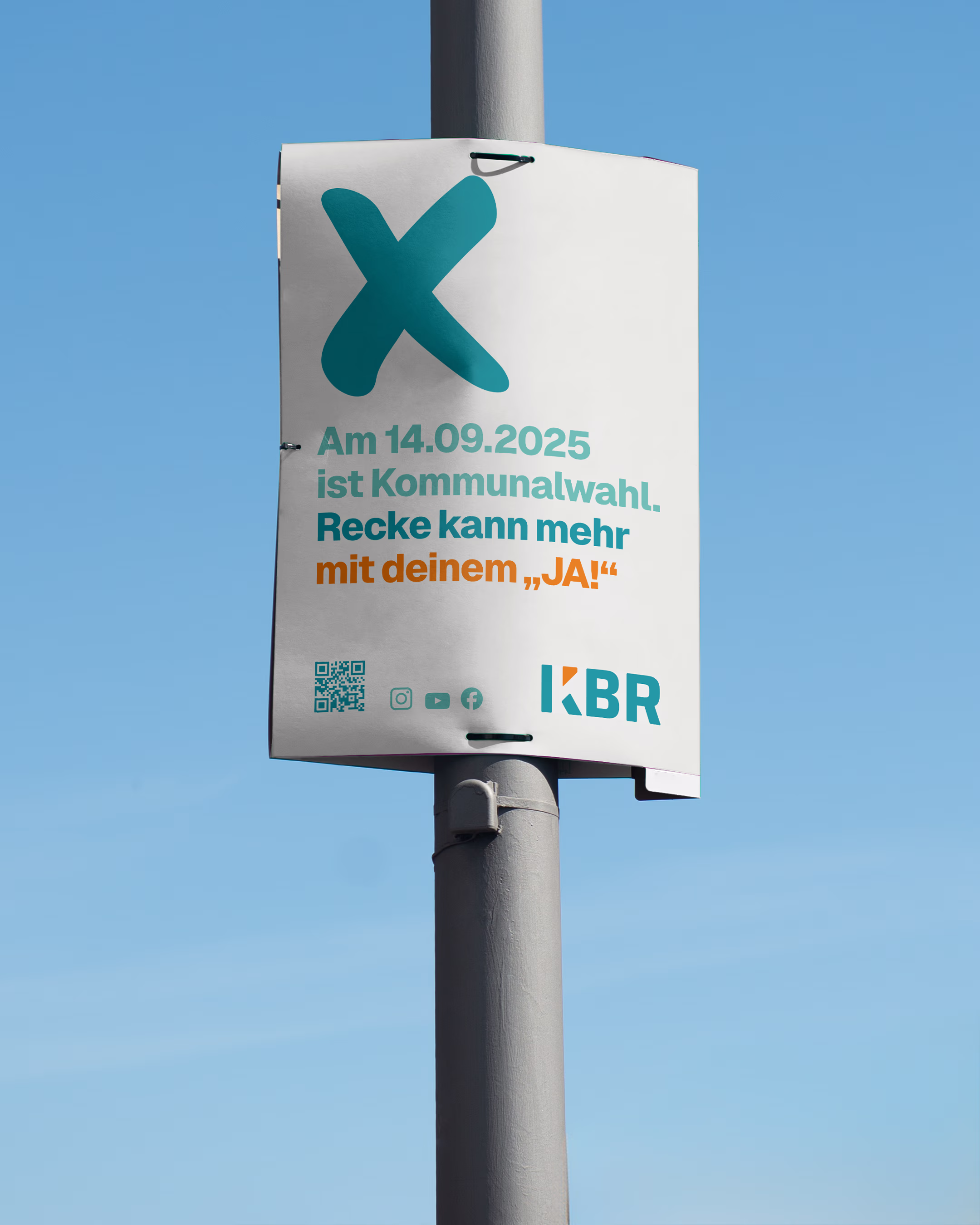 A KBR lamp post poster for the 2025 local elections featuring the campaign slogan “Recke can do more with your ‘Yes!’”, a QR code, and the KBR logo against a blue sky.