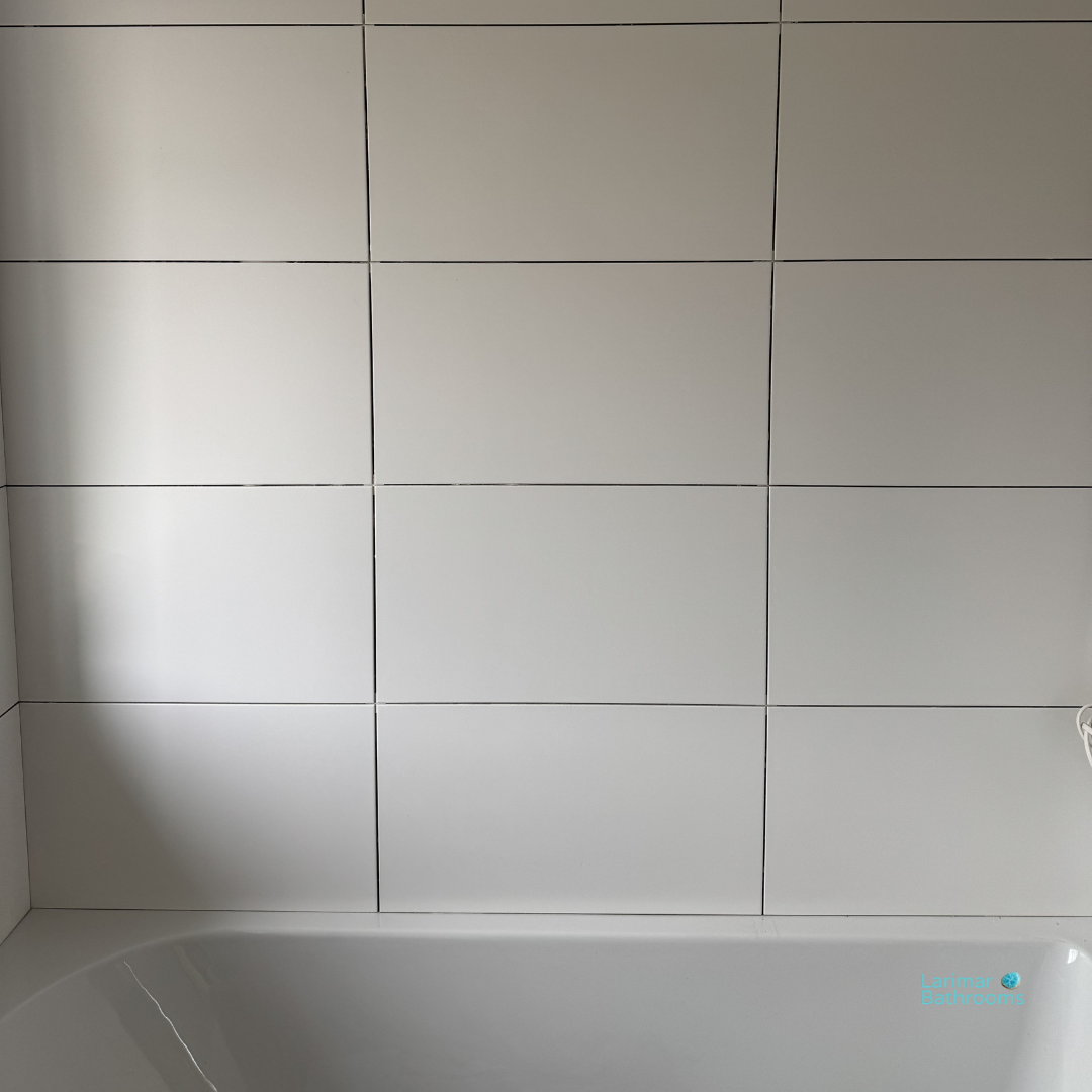 Finished wall tiling with chrome trims and straight bond layout