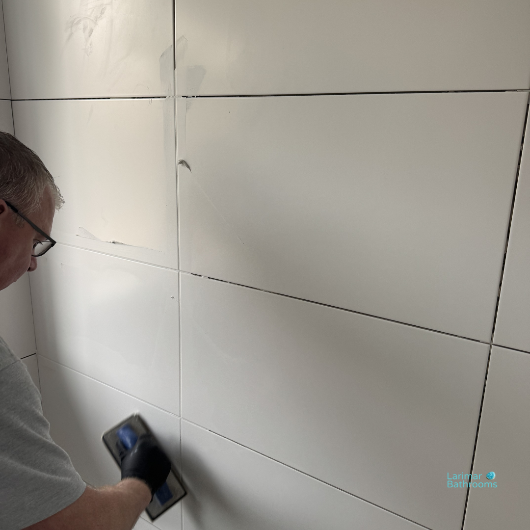 Grouted ceramic wall tiles with white grout and chrome edge trims