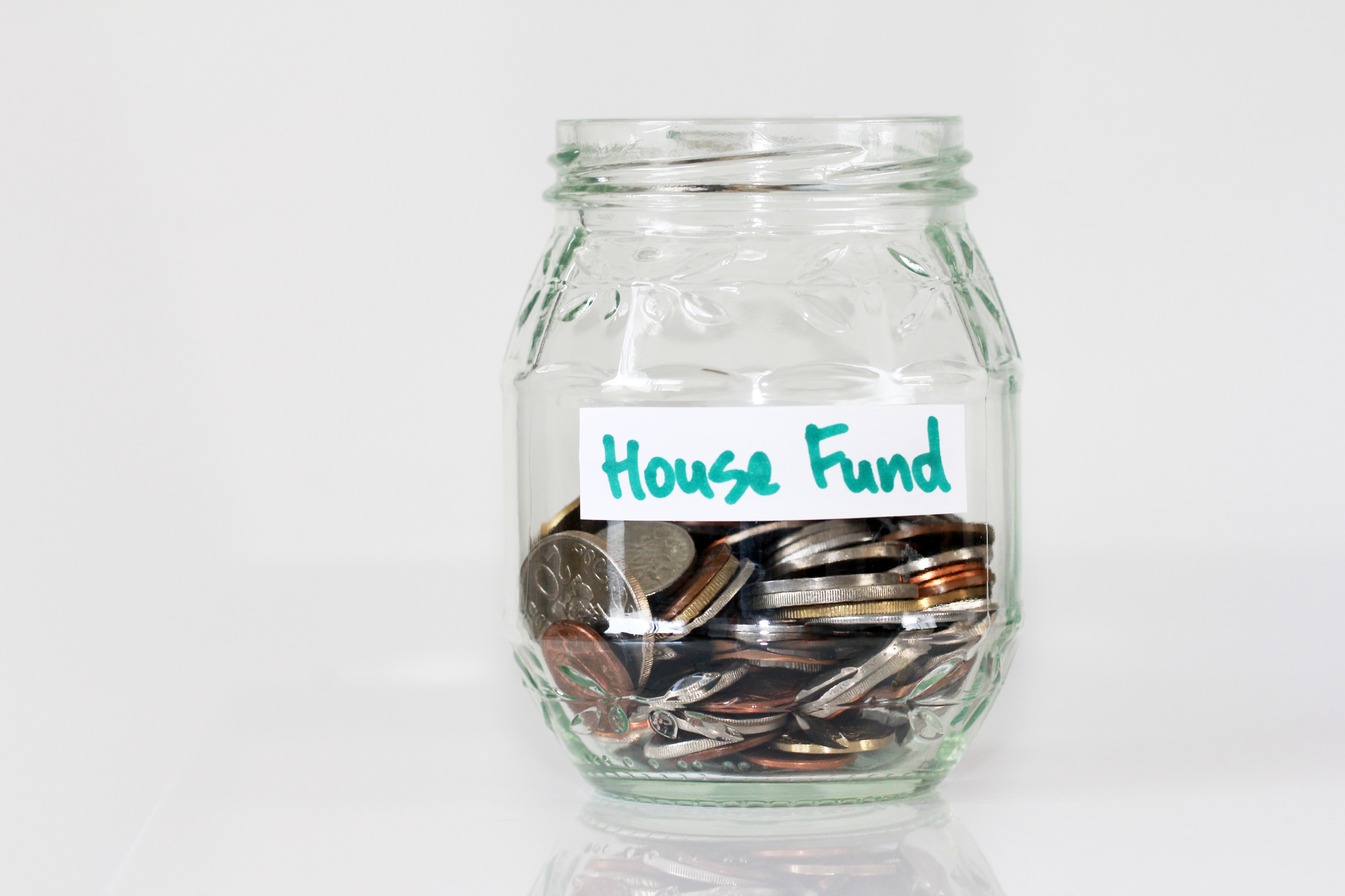 Change in a jar labeled house fund.