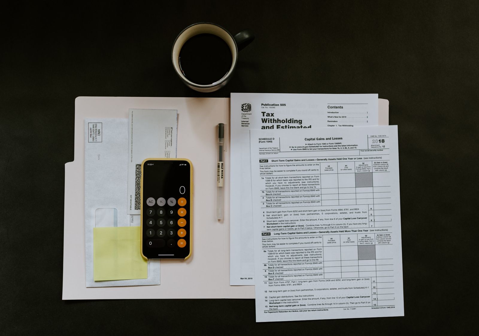 Folder with mortgage documents and phone with calculator.