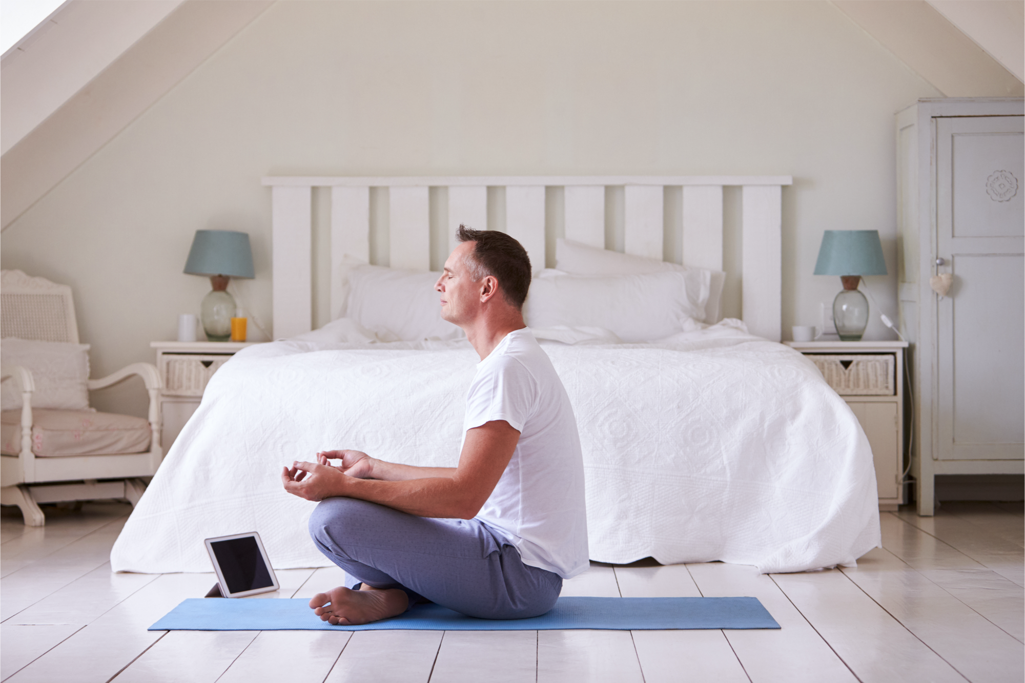 Man meditating in bright home.