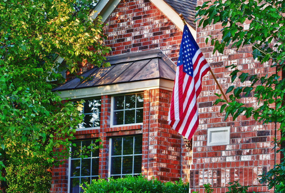 Brick home with American flag.
