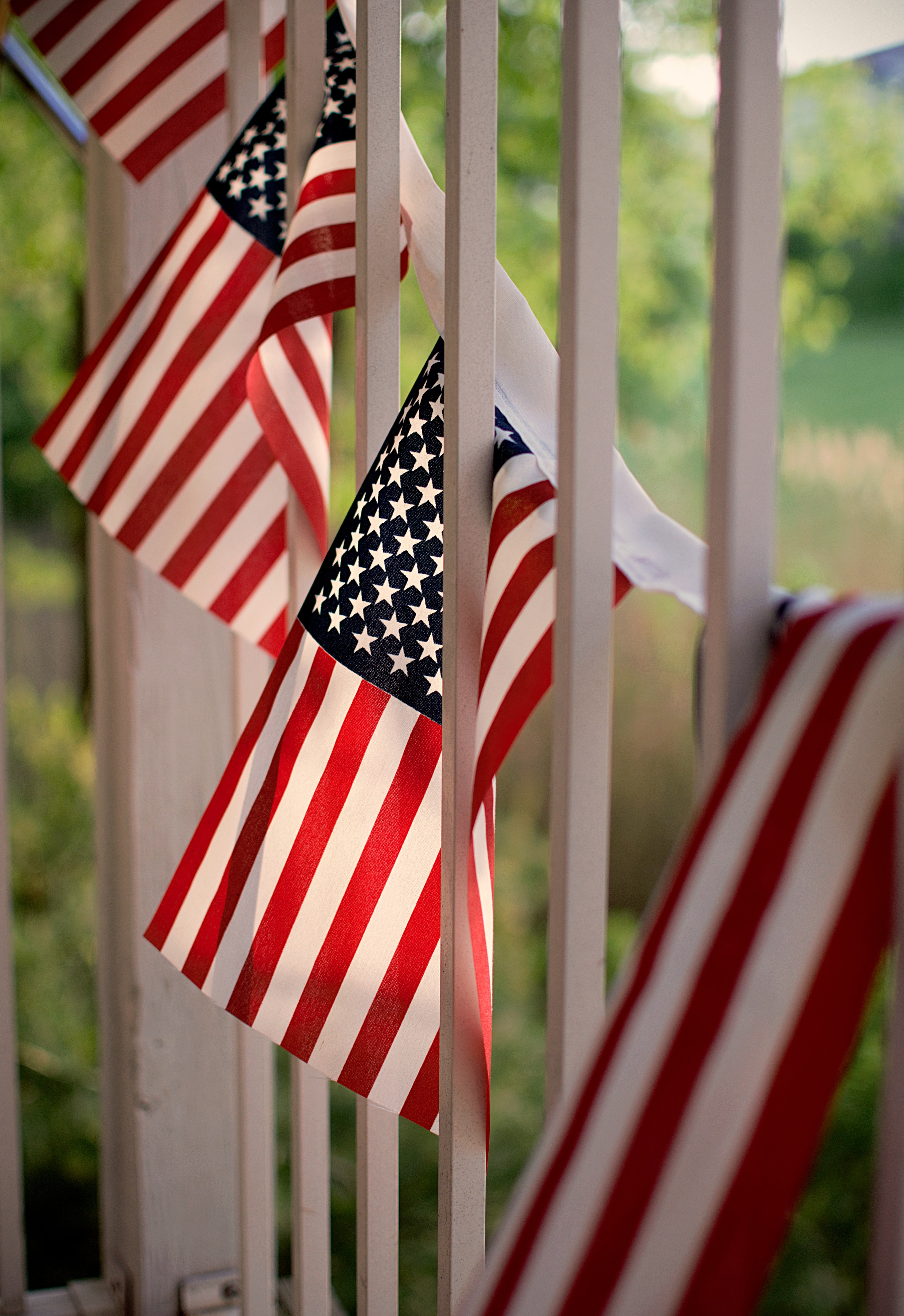 American flags hanging from front porch.