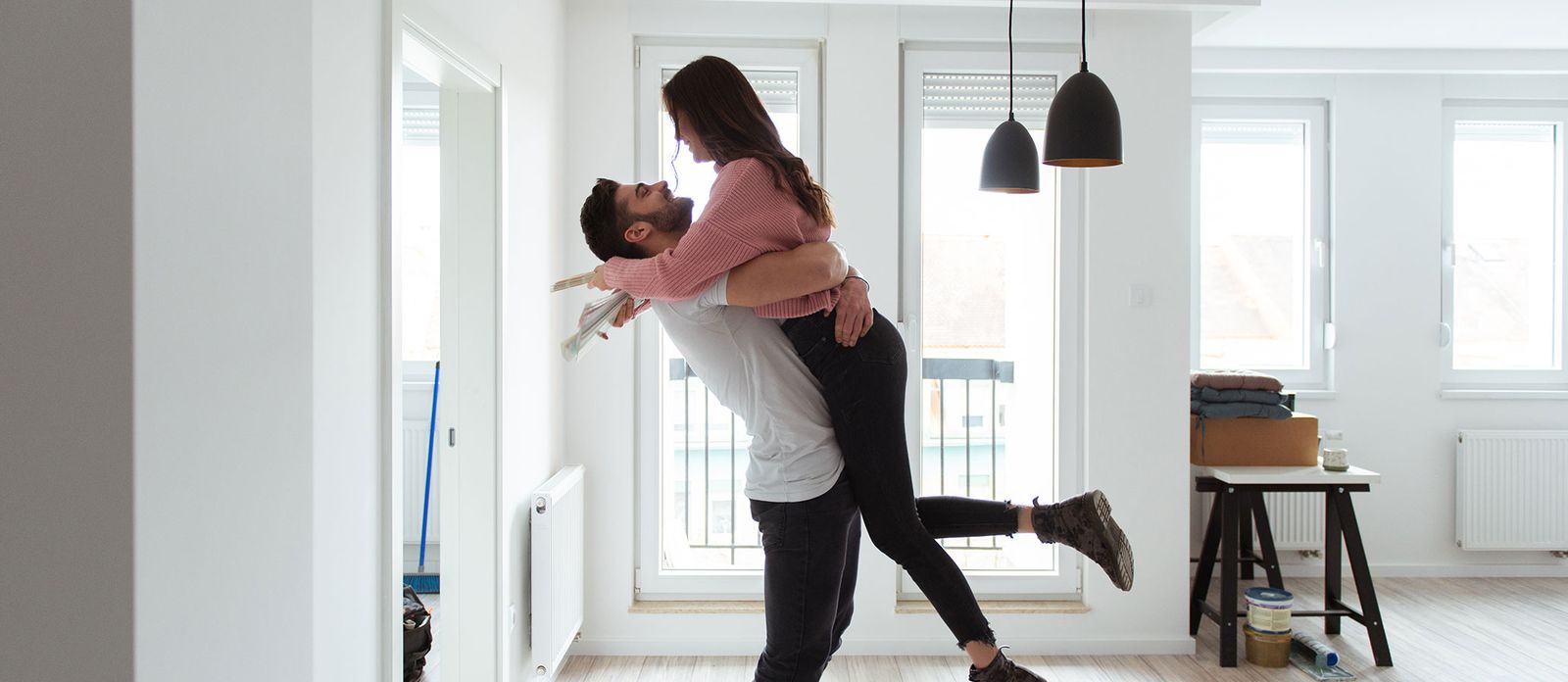 Couple hugging in home. Renting vs. Buying a Home: Compare the Costs