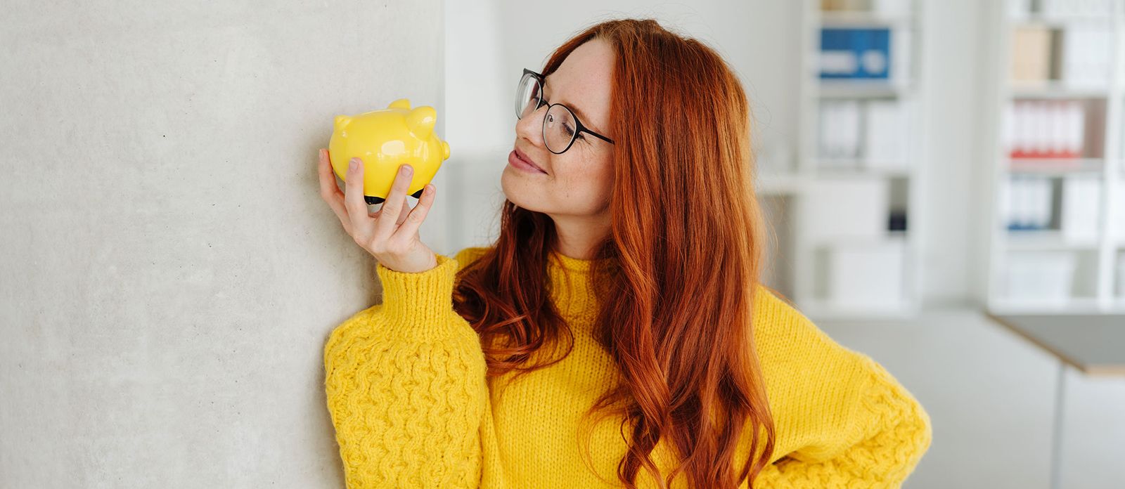 Woman with yellow piggy bank. Your Down payment: Here's How Much Money To Save For Each Loan Type.