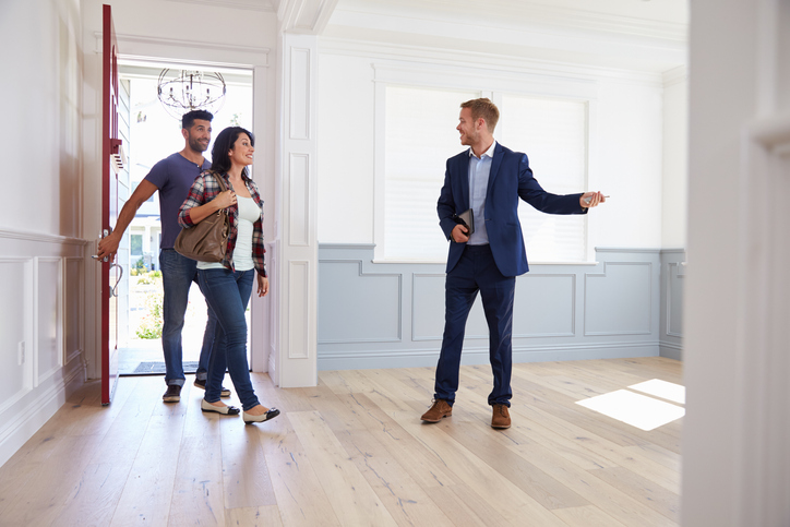 Couple with real estate agent.