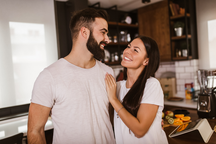Young unmarried couple in home.