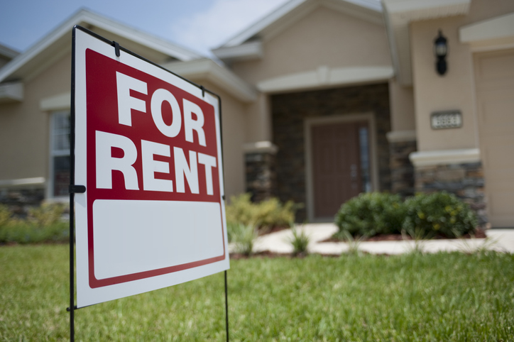 House with for rent sign.