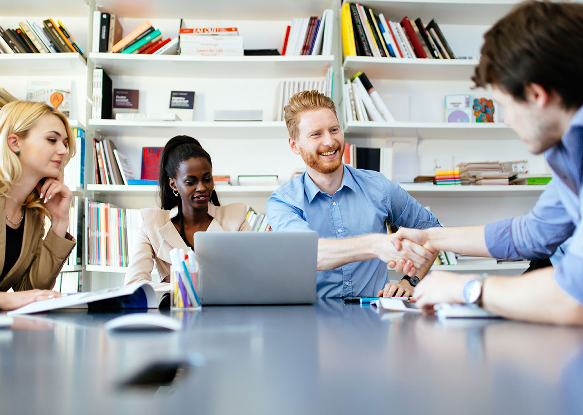 A work meeting with two people shaking hands