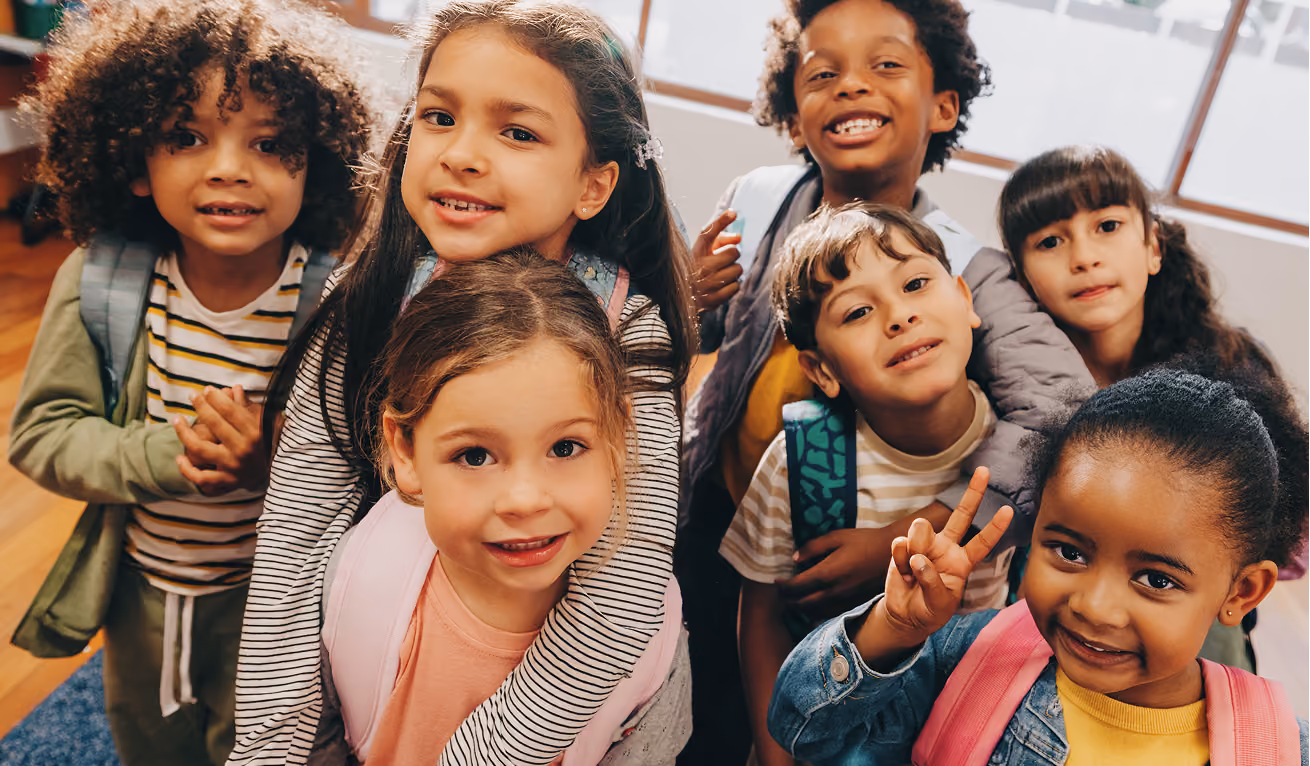 Students in a classroom smiling.
