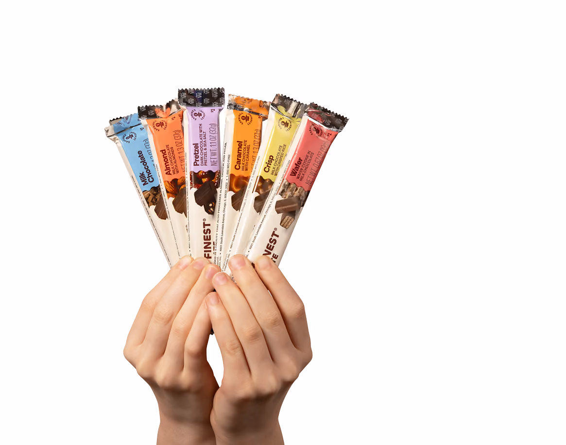 Hands holding a flight of World's Finest Chocolate bars