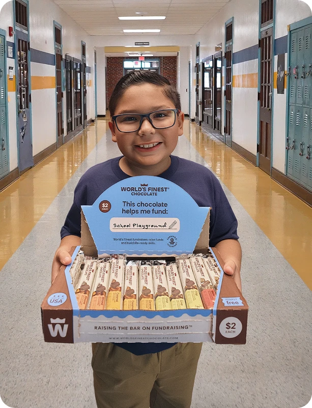 Student holding a WFC case of chocolates in his school hallway.