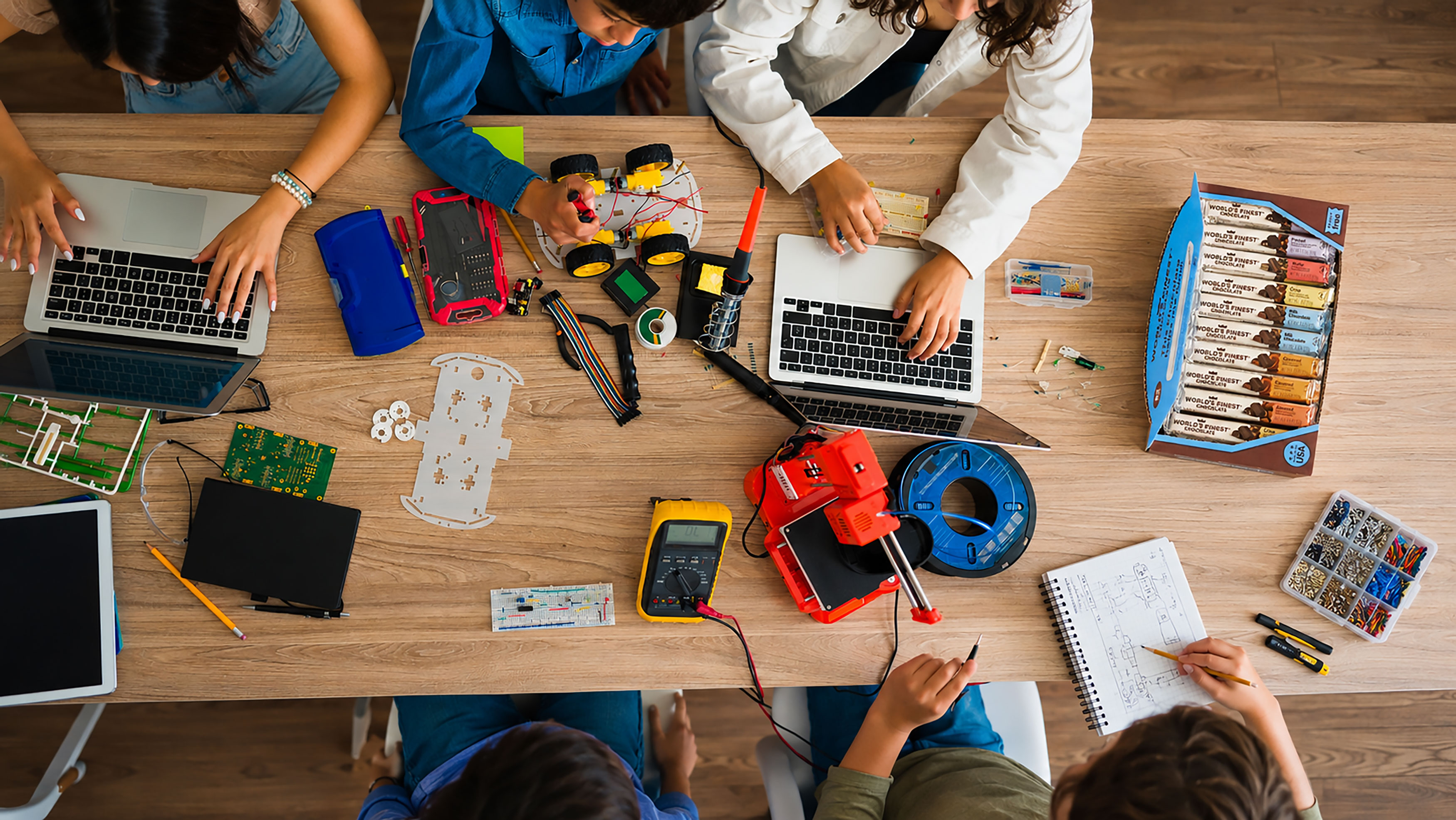 Robotics classroom table with students and their project