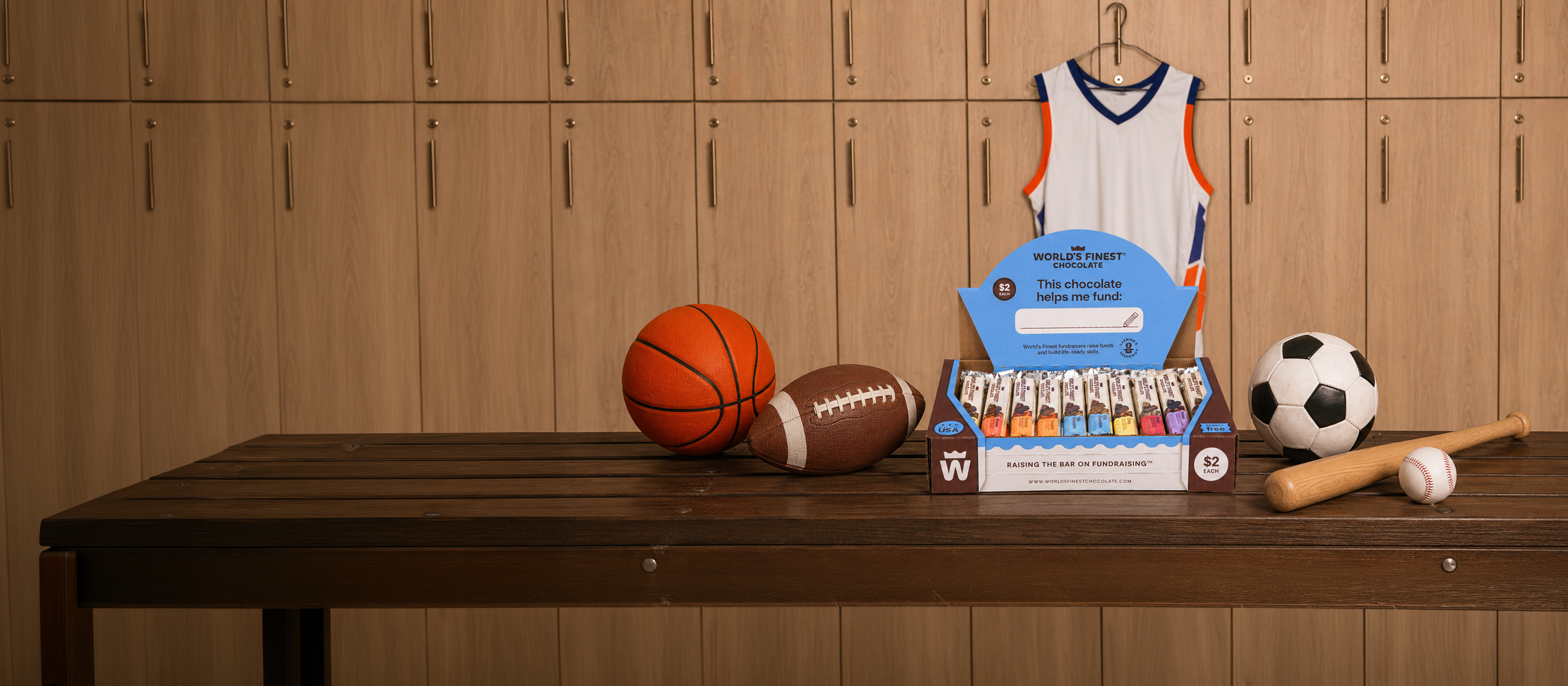 A locker room with sports equipment and a box of World's Finest Chocolate