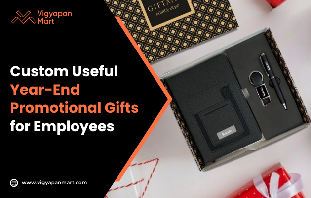Gift set featuring a notebook, pen, keychain, and USB drive in a stylish box. Text reads "Custom Useful Year-End Promotional Gifts for Employees."