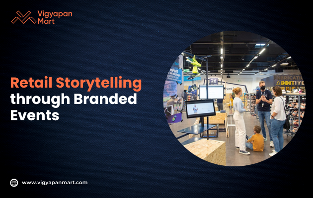 "Retail storytelling event with people engaging around a digital screen in a modern store setting. Vigyapan Mart logo and website are visible."