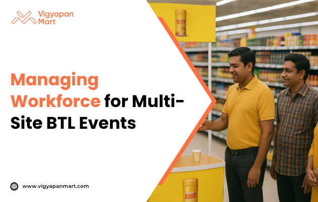 Two smiling men stand at a product display in a store. The image promotes 'Managing Workforce for Multi-Site BTL Events' by Vigyapan Mart.