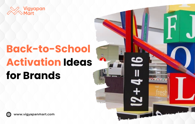 Back-to-school promotional display featuring oversized colored pencils and building blocks with letters and numbers in a store setting. Branding by Vigyapan Mart. Text on image reads 'Back-to-School Activation Ideas for Brands.