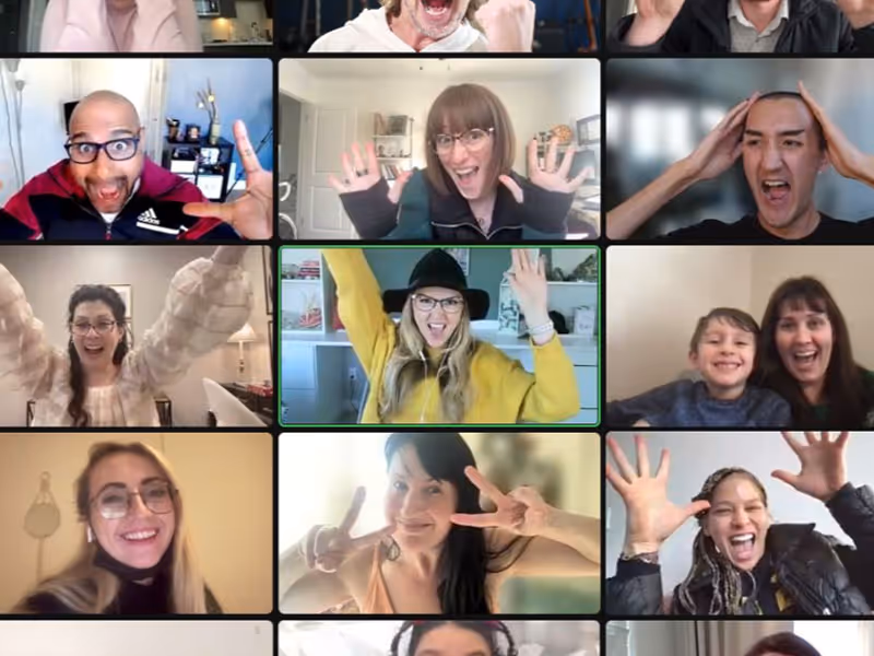 Grid of diverse people smiling and making energetic gestures during a video call.