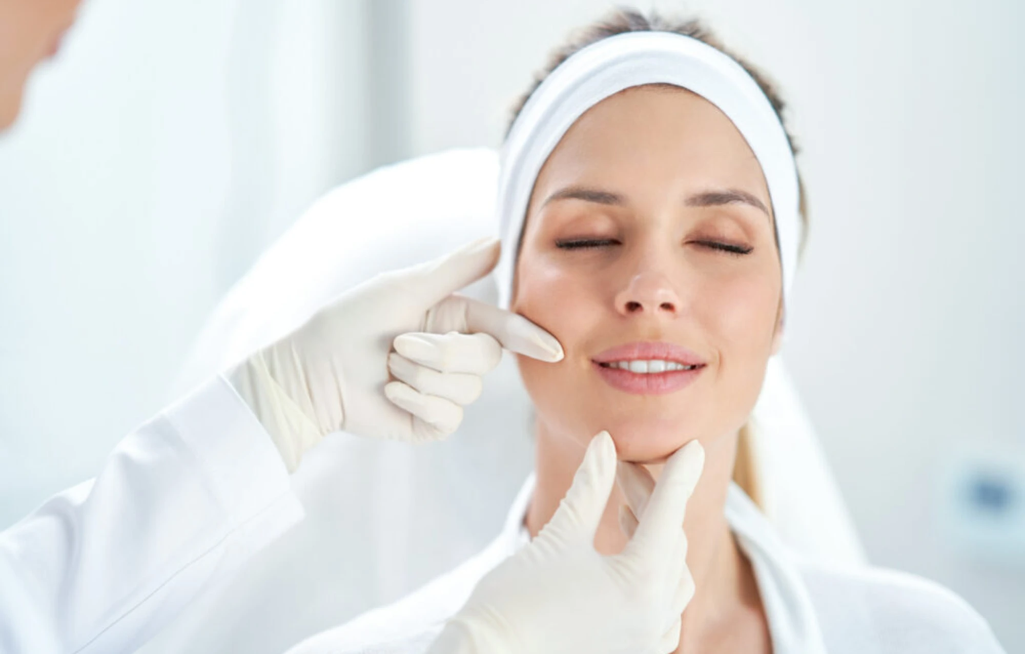Woman receiving a holistic facial treatment for mind-body balance at a spa.