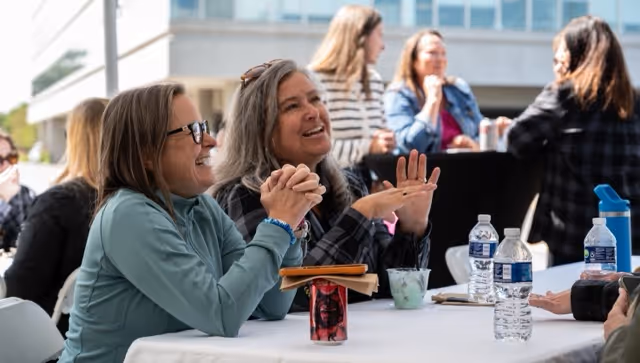 Smiling Alteris Employees enjoying an outdoor company meeting