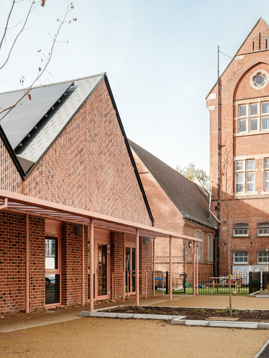 A photo of the new teaching block to the left, with the existing Victorian school building to the right. 
