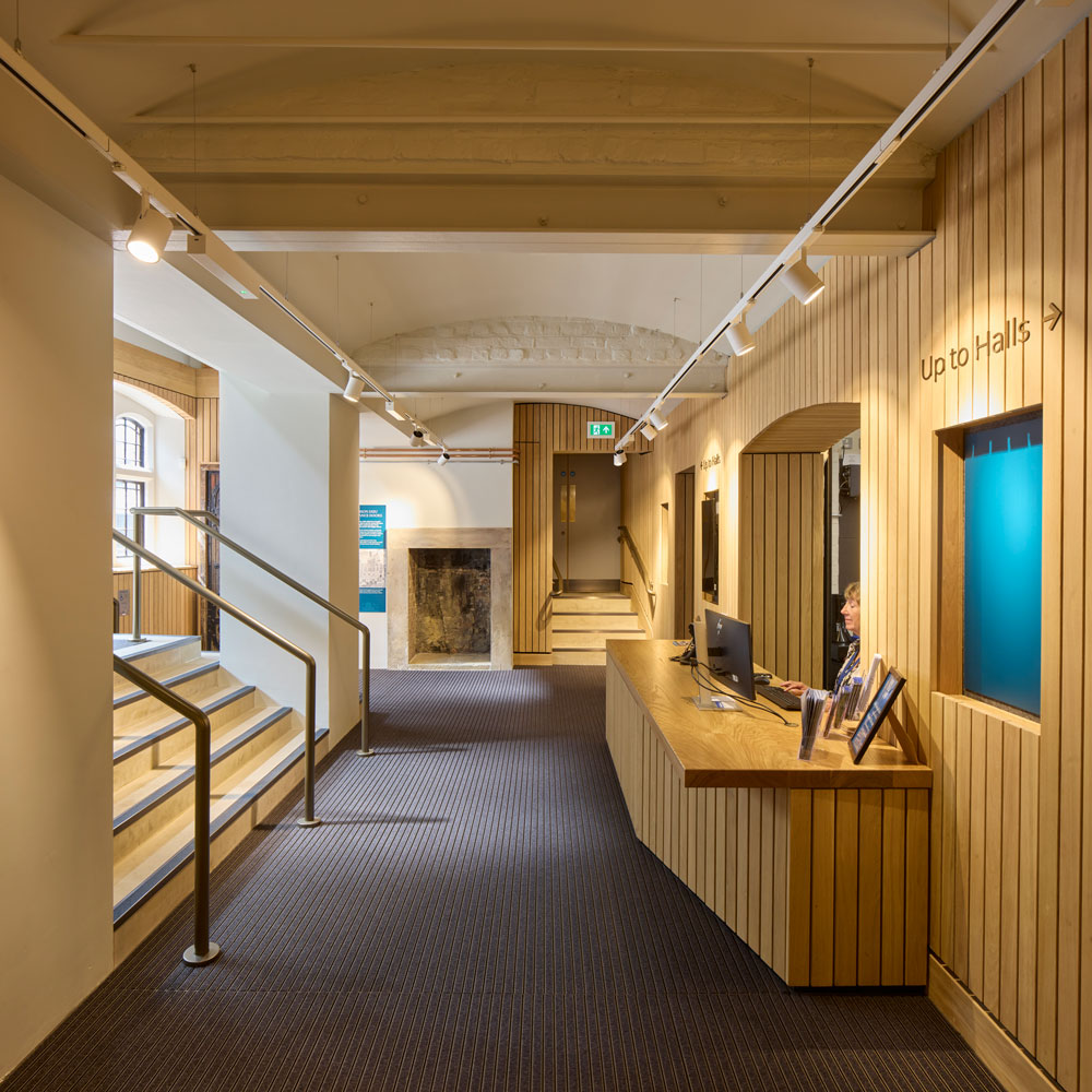 The new accessible high-street entrance that leads into the foyer. The receptionist’s desk is framed by
neutral wooden panelling.
