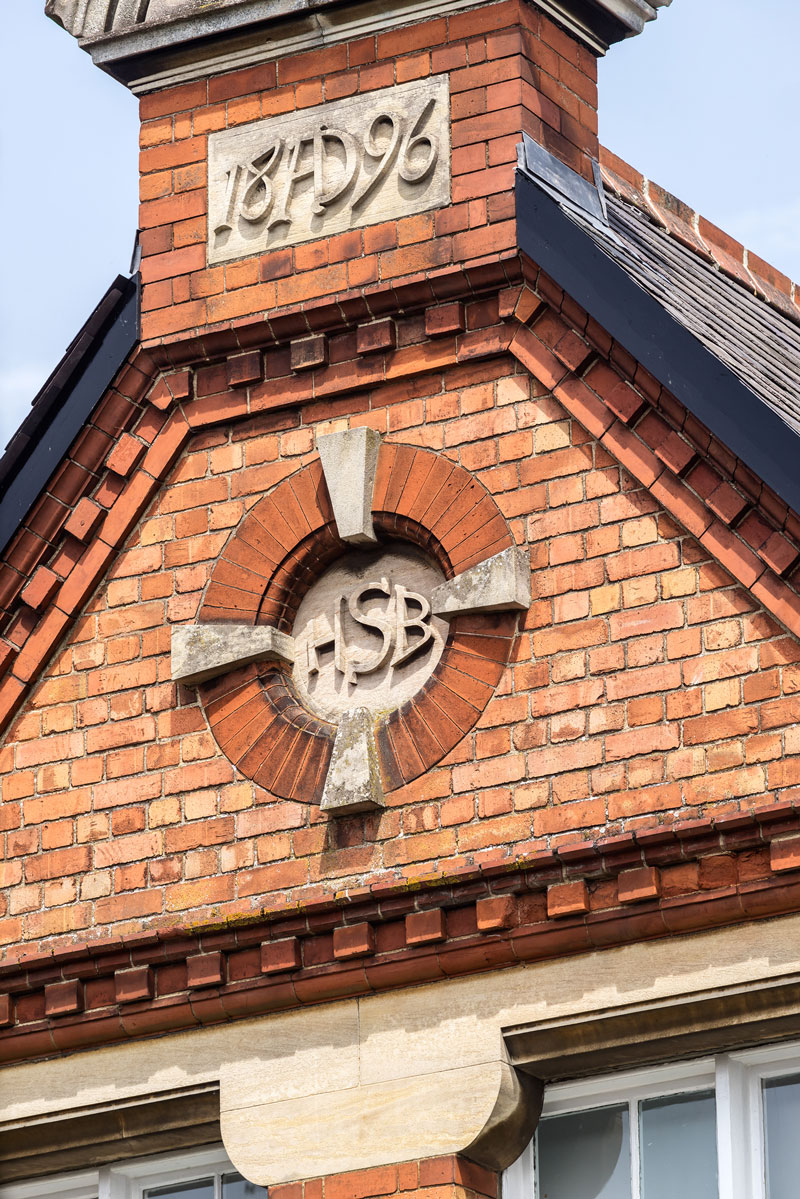 Detail shot of the London Board School emblem in the brickwork on the original school buildi