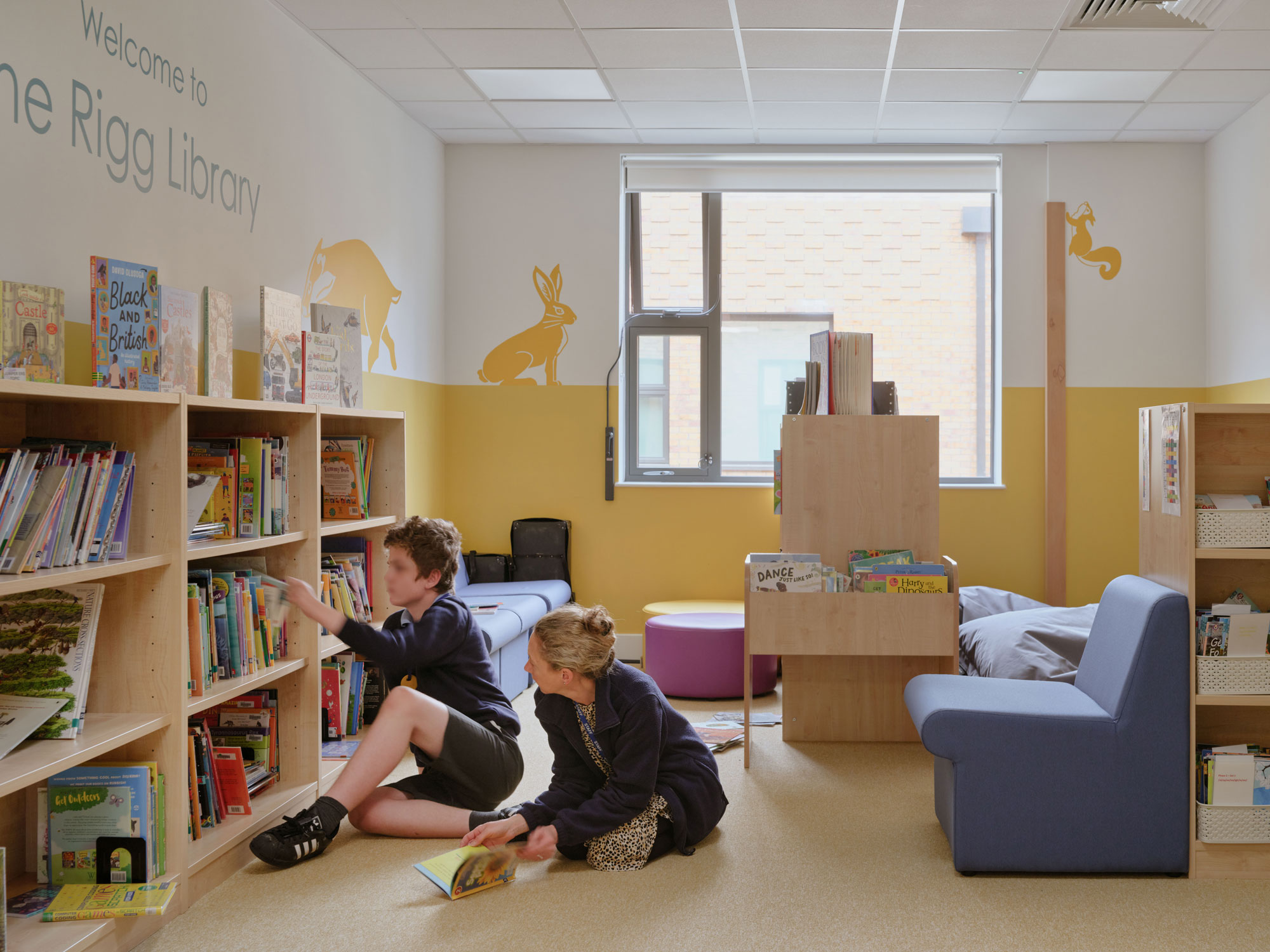 A student and teacher in the library at Hawthorns School 