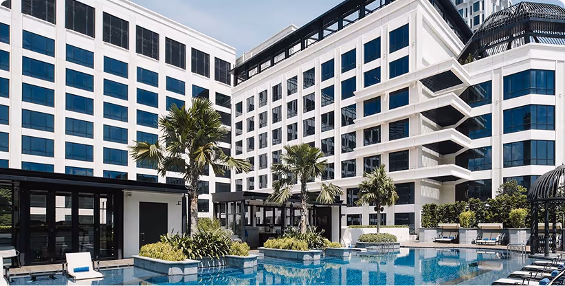 glass hotel with a swimming pool.
