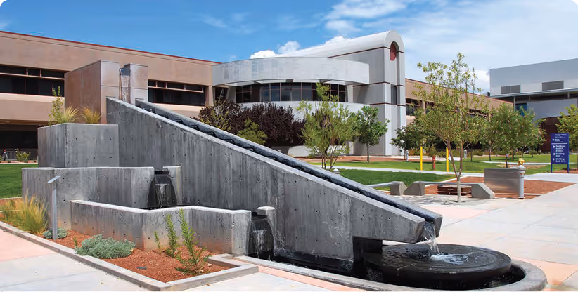 A modern government building with a fountain in front.