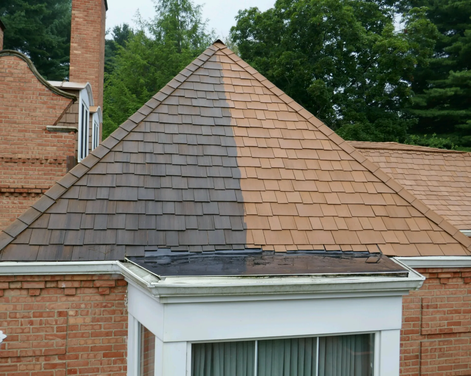 shingle roof with the left side showing before the power wash, and the right side showing after the power wash