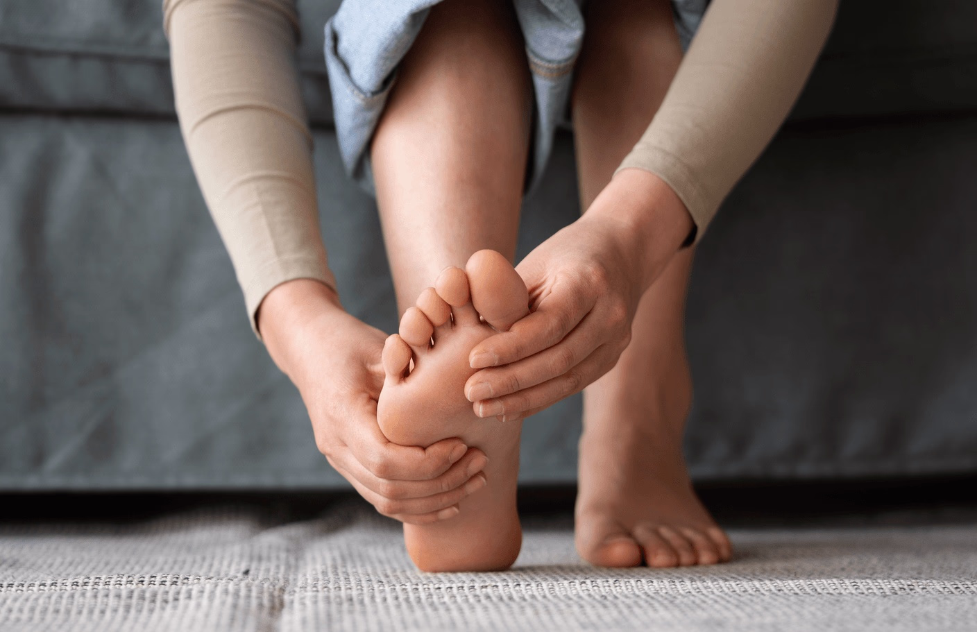 Woman experiencing foot pain caused by a bunion while seeking treatment from the best foot surgeon for bunion in Los Angeles, CA, for improved comfort and mobility.