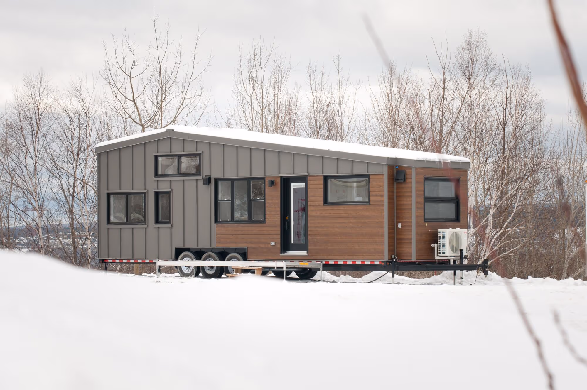 Noyer XL modern tiny home on wheels in winter snow