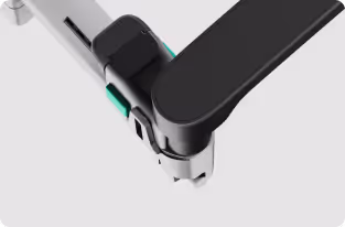 Close-up of a mechanical joint with black and white components and green accents.