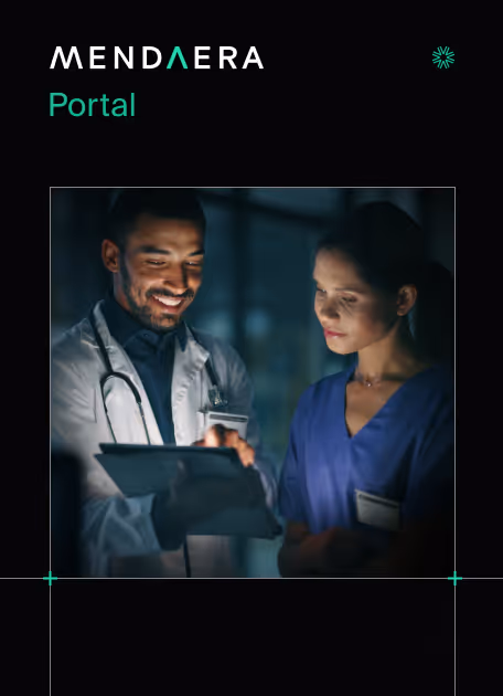 Smiling male doctor and female nurse reviewing information on a digital tablet in a dimly lit medical setting.