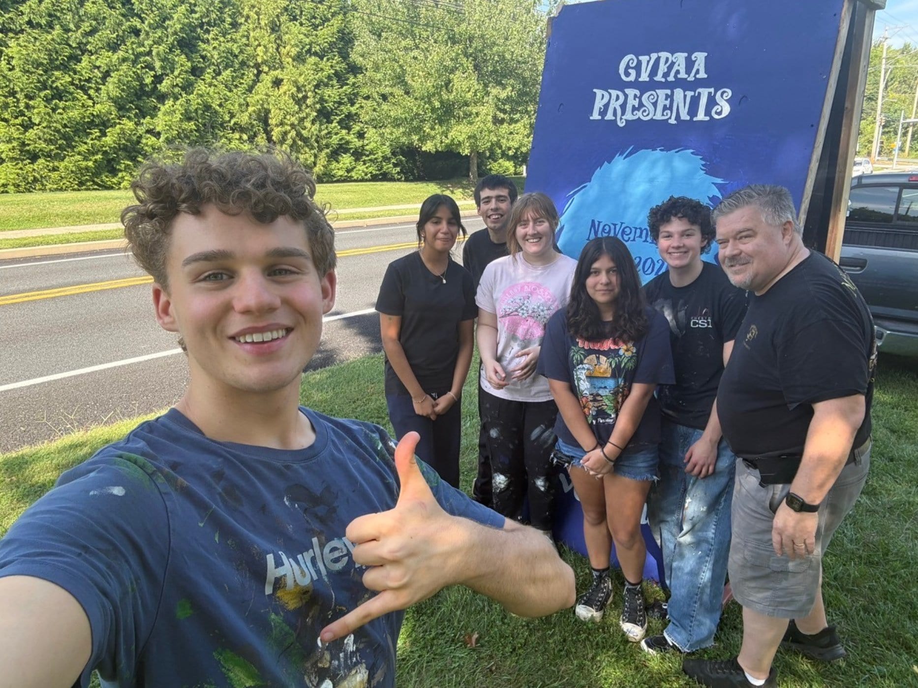 Picture of crew with advertisment roadsign