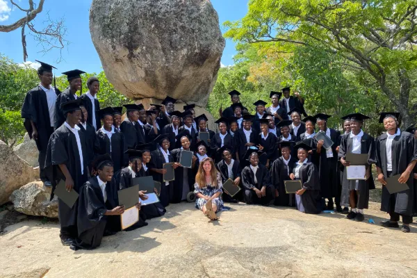 Graduates in caps and gowns with certificates celebrate Education Matters school in Zimbabwe accomplishment.