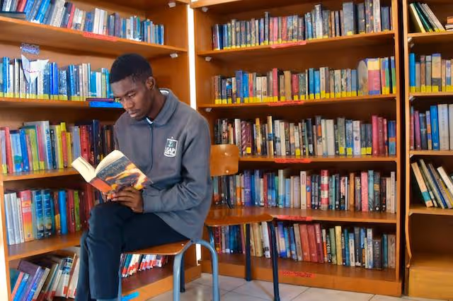 A student sat in a library reading a book