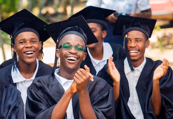 Students in graduation attire happy and smiling
