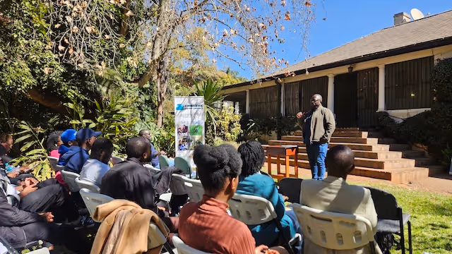 Students at Education Matters school in Zimbabwe, Africa, gather for outdoor learning sessions together effectively.